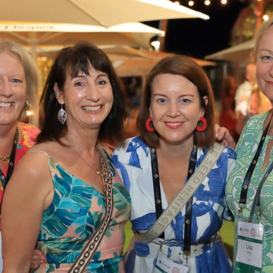 four women at a conference