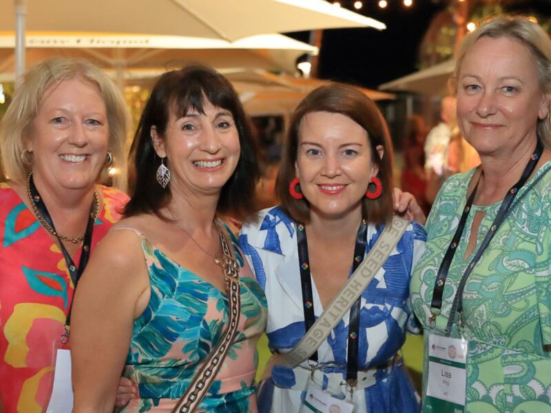 four women at a conference
